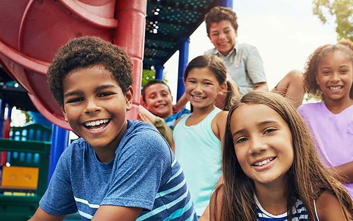 Children at a playground, smiling